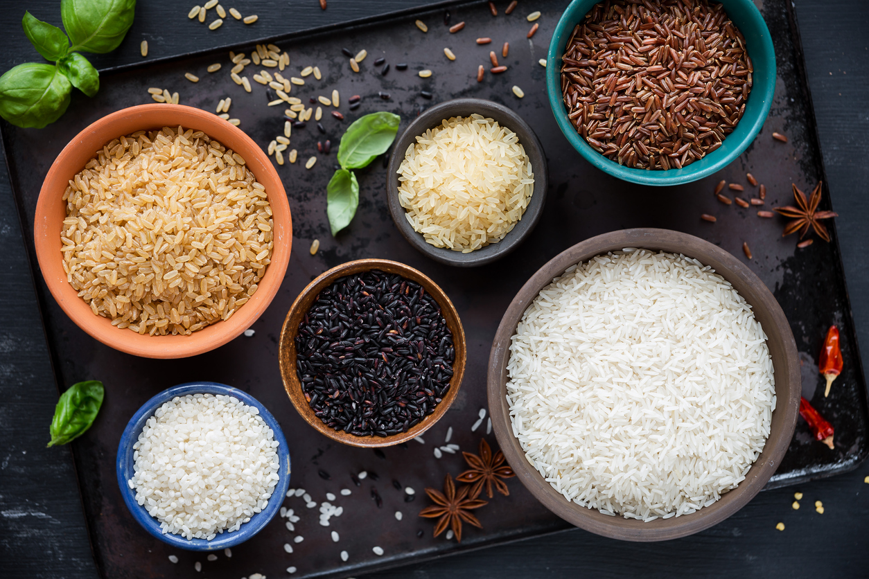 Variety of rice grains in wooden bowls